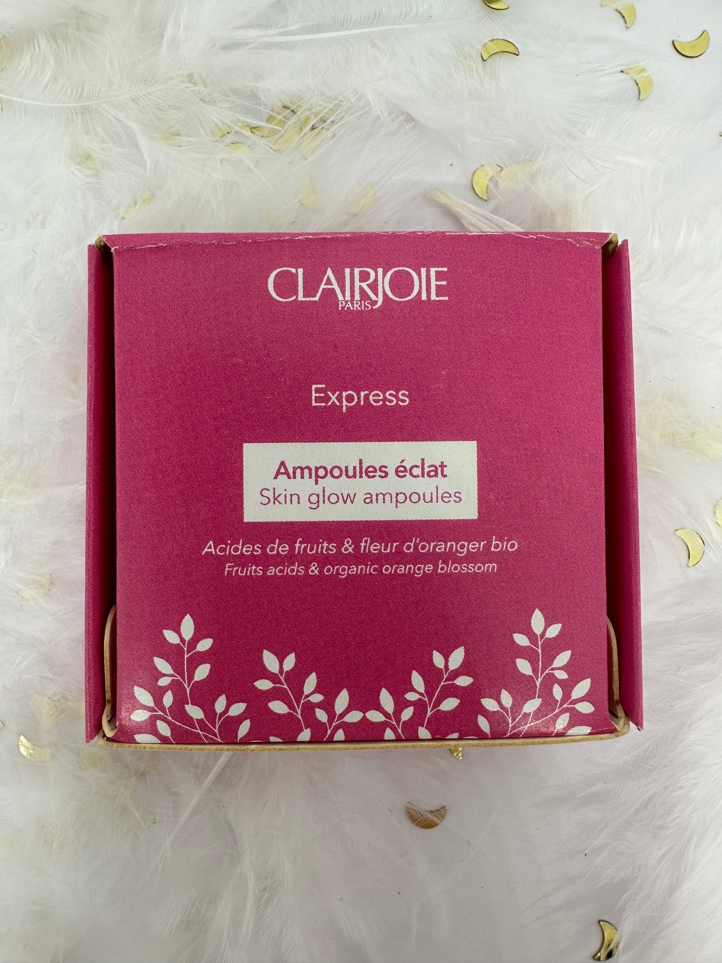 boite de 5 ampoules éclat visage rose sur fond blanc avec plumes blanches, paillettes dorées